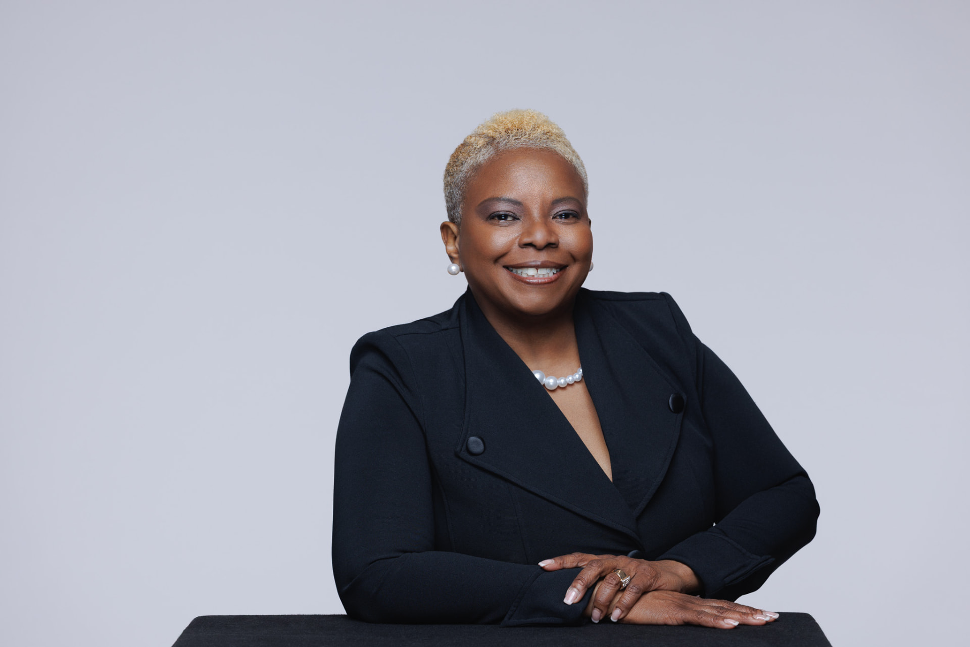 Robben Washington seated with her hands resting on the desk
